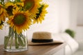 Beautiful yellow sunflowers on wooden table in room, space for text Royalty Free Stock Photo