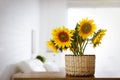 Beautiful yellow sunflowers on wooden table in room, space for text Royalty Free Stock Photo