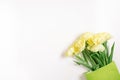 Beautiful yellow tulip flowers in a green paper bag with space for text. The concept of sales, spring discounts, shopping and Royalty Free Stock Photo