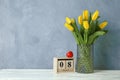 Beautiful yellow tulips in a glass vase on white background for Mother`s Day Royalty Free Stock Photo