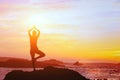 Beautiful yoga background, silhouette of woman on the beach at sunset, mindfulness