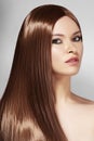 Beautiful yong Woman with Long Straight Brown Hair. Fashion Model with Smooth Gloss Hairstyle. Keratine Treatment Royalty Free Stock Photo