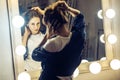 Beautiful young adult freckles woman looking at her reflection i Royalty Free Stock Photo