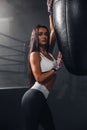 Beautiful young adult girl posing happy with boxing bag Royalty Free Stock Photo