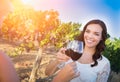 Beautiful Young Adult Woman Enjoying Glass of Wine Tasting Toast In The Vineyard with Friends Royalty Free Stock Photo