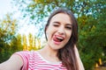 Beautiful young adult woman taking picture of herself, selfie Royalty Free Stock Photo