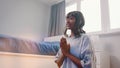 Beautiful young african american black woman meditating in her bedroom. first meditation attempt with smile on her face Royalty Free Stock Photo