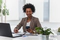 Beautiful young african american businesswoman working on computer at her office Royalty Free Stock Photo