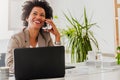 Beautiful young african american businesswoman working on computer at her office Royalty Free Stock Photo