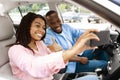 Happy black couple driving car and taking selfie on smartphone Royalty Free Stock Photo