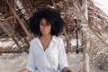 beautiful young african american girl sitting on sand at the beach Royalty Free Stock Photo