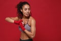 Beautiful young african american sports fitness boxer woman in sportswear posing working out isolated on red wall Royalty Free Stock Photo