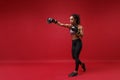 Beautiful young african american sports fitness boxer woman in sportswear working out  on red background. Sport Royalty Free Stock Photo