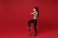 Beautiful young african american sports fitness woman in sportswear posing working out  on red background. Sport Royalty Free Stock Photo