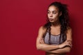 Beautiful young african american sports fitness woman in sportswear posing working out  on red wall background Royalty Free Stock Photo