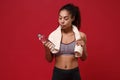 Beautiful young african american sports fitness woman in sportswear working out isolated on red background. Sport Royalty Free Stock Photo