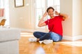 Beautiful young african american woman with afro hair listening to music and dancing wearing headphones Royalty Free Stock Photo