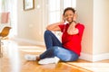 Beautiful young african american woman with afro hair listening to music and dancing wearing headphones Royalty Free Stock Photo