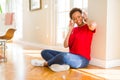 Beautiful young african american woman with afro hair listening to music and dancing wearing headphones Royalty Free Stock Photo