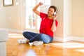 Beautiful young african american woman with afro hair listening to music and dancing wearing headphones Royalty Free Stock Photo