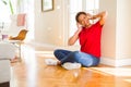 Beautiful young african american woman with afro hair listening to music and dancing wearing headphones Royalty Free Stock Photo