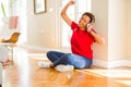 Beautiful young african american woman with afro hair listening to music and dancing wearing headphones Royalty Free Stock Photo