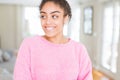 Beautiful young african american woman with afro hair smiling looking side and staring away thinking Royalty Free Stock Photo