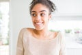 Beautiful young african american woman with afro hair smiling looking side and staring away thinking Royalty Free Stock Photo