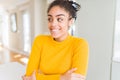 Beautiful young african american woman with afro hair smiling looking side and staring away thinking Royalty Free Stock Photo