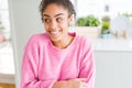 Beautiful young african american woman with afro hair smiling looking side and staring away thinking Royalty Free Stock Photo