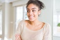 Beautiful young african american woman with afro hair smiling looking side and staring away thinking Royalty Free Stock Photo