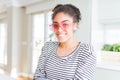 Beautiful young african american woman with afro hair wearing crazy pink heart glasses with a happy and cool smile on face