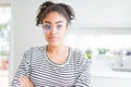 Beautiful young african american woman with afro hair wearing glasses Relaxed with serious expression on face Royalty Free Stock Photo