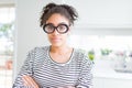 Beautiful young african american woman with afro hair wearing glasses Relaxed with serious expression on face Royalty Free Stock Photo