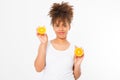 Beautiful young african american woman isolated with oranges on white background. Afro girl and diet concept. Copy space. Skin Royalty Free Stock Photo