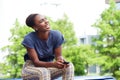 Beautiful young african american woman laughing with mobile phone outdoors Royalty Free Stock Photo