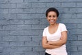 Beautiful young african american woman smiling against gray wall Royalty Free Stock Photo
