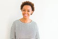 Beautiful young african american woman smiling confident to the camera showing teeth over isolated white background Royalty Free Stock Photo