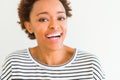 Beautiful young african american woman smiling confident to the camera showing teeth over isolated white background Royalty Free Stock Photo