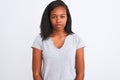 Beautiful young african american woman wearing casual t-shirt over isolated background with serious expression on face Royalty Free Stock Photo