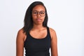 Beautiful young african american woman wearing glasses over isolated background with serious expression on face Royalty Free Stock Photo