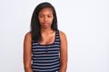 Beautiful young african american woman wearing summer t-shirt over isolated background with serious expression on face Royalty Free Stock Photo