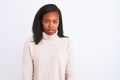 Beautiful young african american woman wearing turtleneck sweater over isolated background with serious expression on face Royalty Free Stock Photo