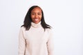 Beautiful young african american woman wearing turtleneck sweater and winter hat with a happy and cool smile on face Royalty Free Stock Photo