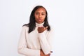 Beautiful young african american woman wearing turtleneck sweater and winter hat looking at the camera blowing a kiss with hand on Royalty Free Stock Photo