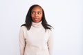 Beautiful young african american woman wearing turtleneck sweater and winter hat smiling looking to the side and staring away Royalty Free Stock Photo