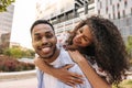 Beautiful young african couple in love spends leisure time walking together in open air. Royalty Free Stock Photo