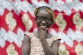 Beautiful Young african girl with traditional accessories in hair smiling at camera