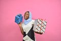 beautiful young african woman holding two gift boxes feeling excited and happy Royalty Free Stock Photo