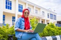 Beautiful young African woman smiling while using her laptop outside Royalty Free Stock Photo